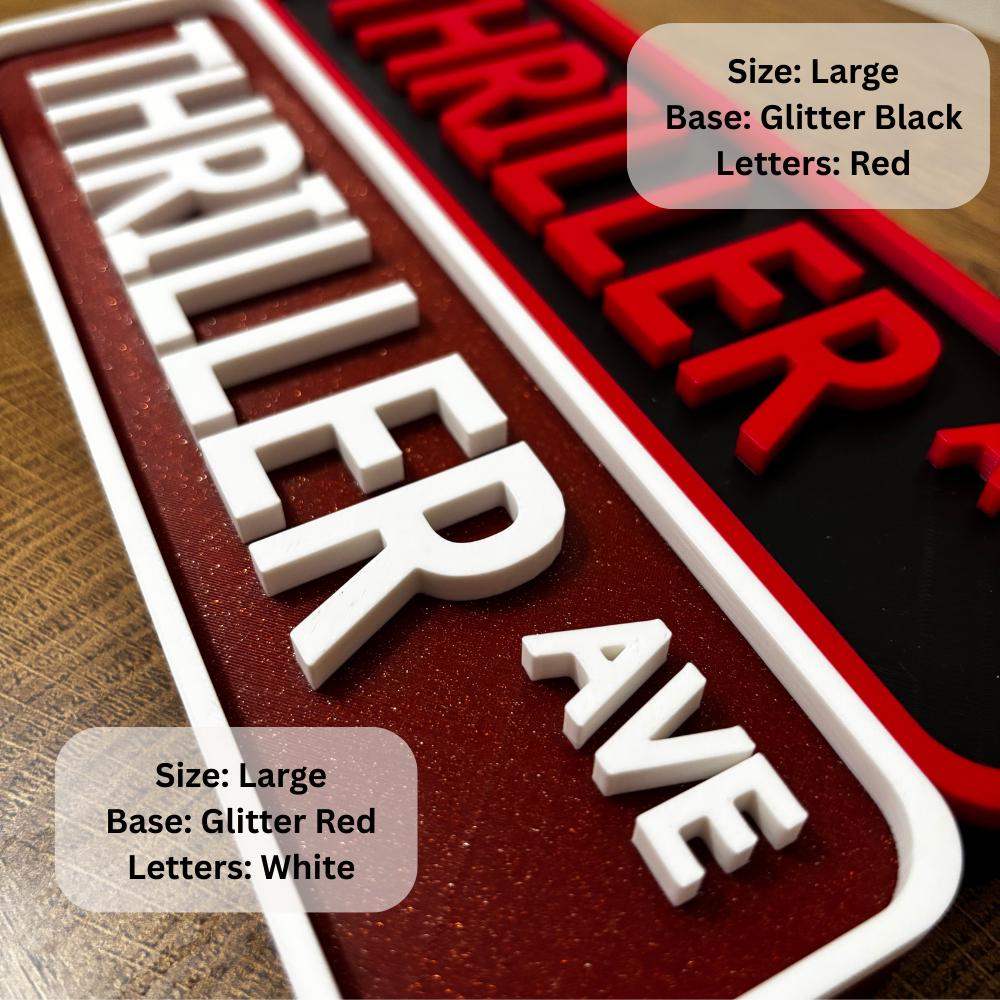 Two "THRILLER AVE" street signs shown; one with a glitter red base and white letters, and one with a glitter black base and red letters. Both labeled as size large. __etsy:7216750843