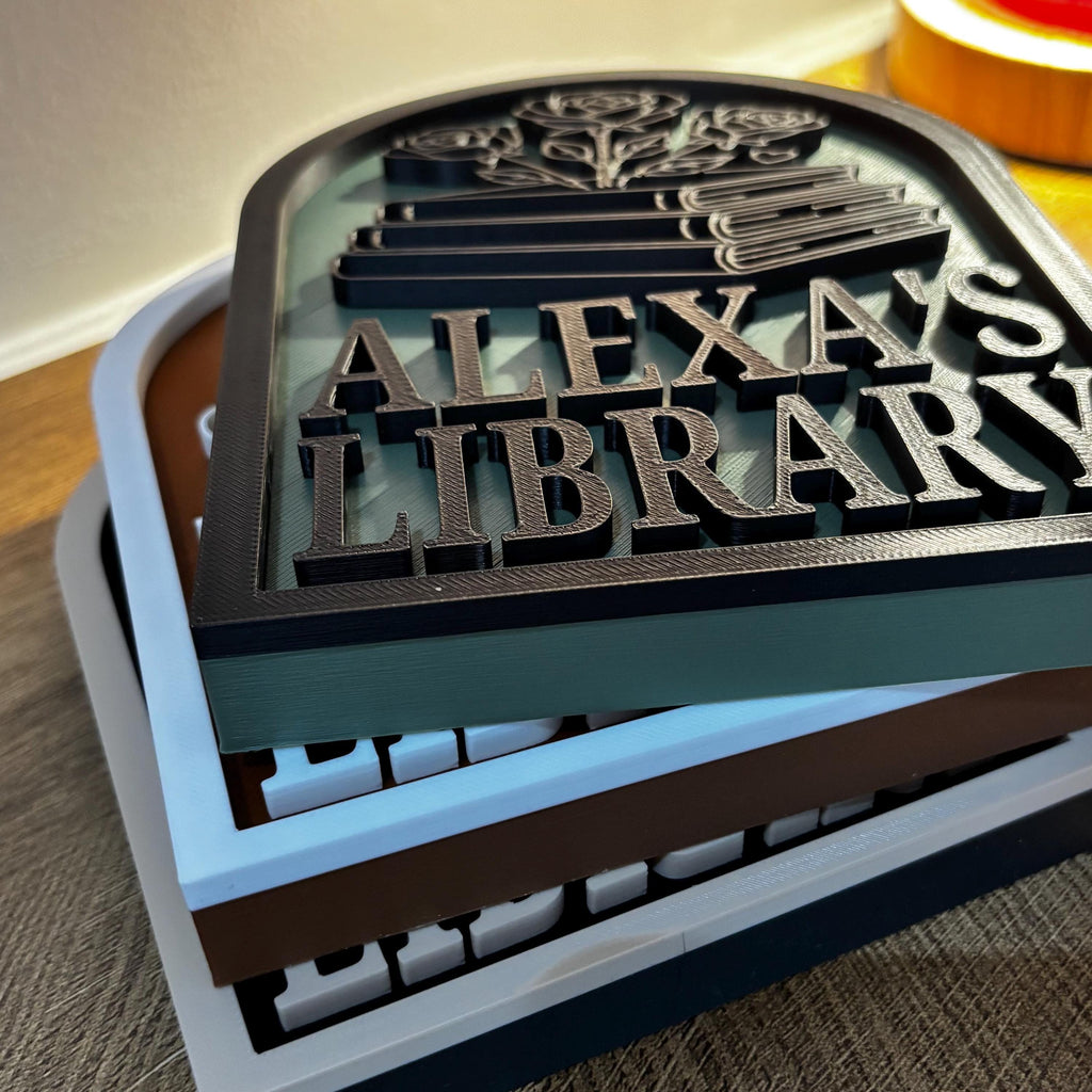 Personalized bookshelf sign with raised text and book and flower design for home library decor