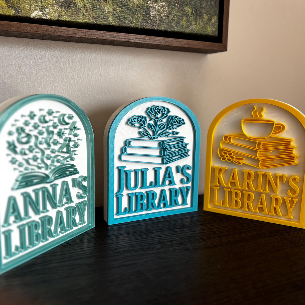 Custom bookshelf signs for personal library, featuring books, flowers, and teacup designs.