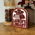 Personalized library sign with stacked books and roses, custom bookshelf decor on wooden table