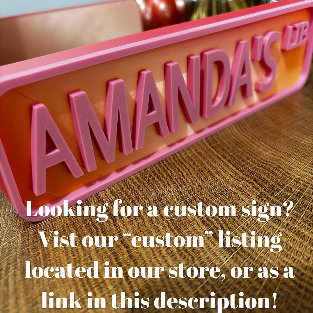 Custom pink and red AMANDA'S LIB street sign with text about ordering a custom sign