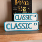 Front view of the small and large teal and white CLASSIC CT street signs