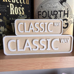 Front view of the small and large beige and white CLASSIC WAY street signs