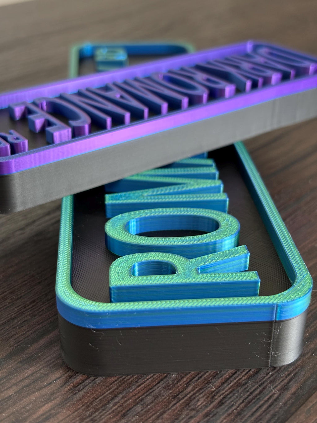 Top view of street signs printed in blue green silk and blue purple silk filament